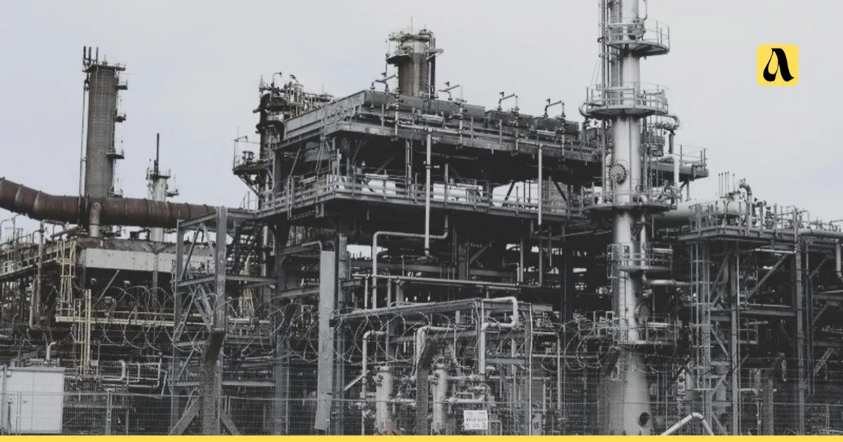 Nigerian oil refinery seen through razor-wire fencing